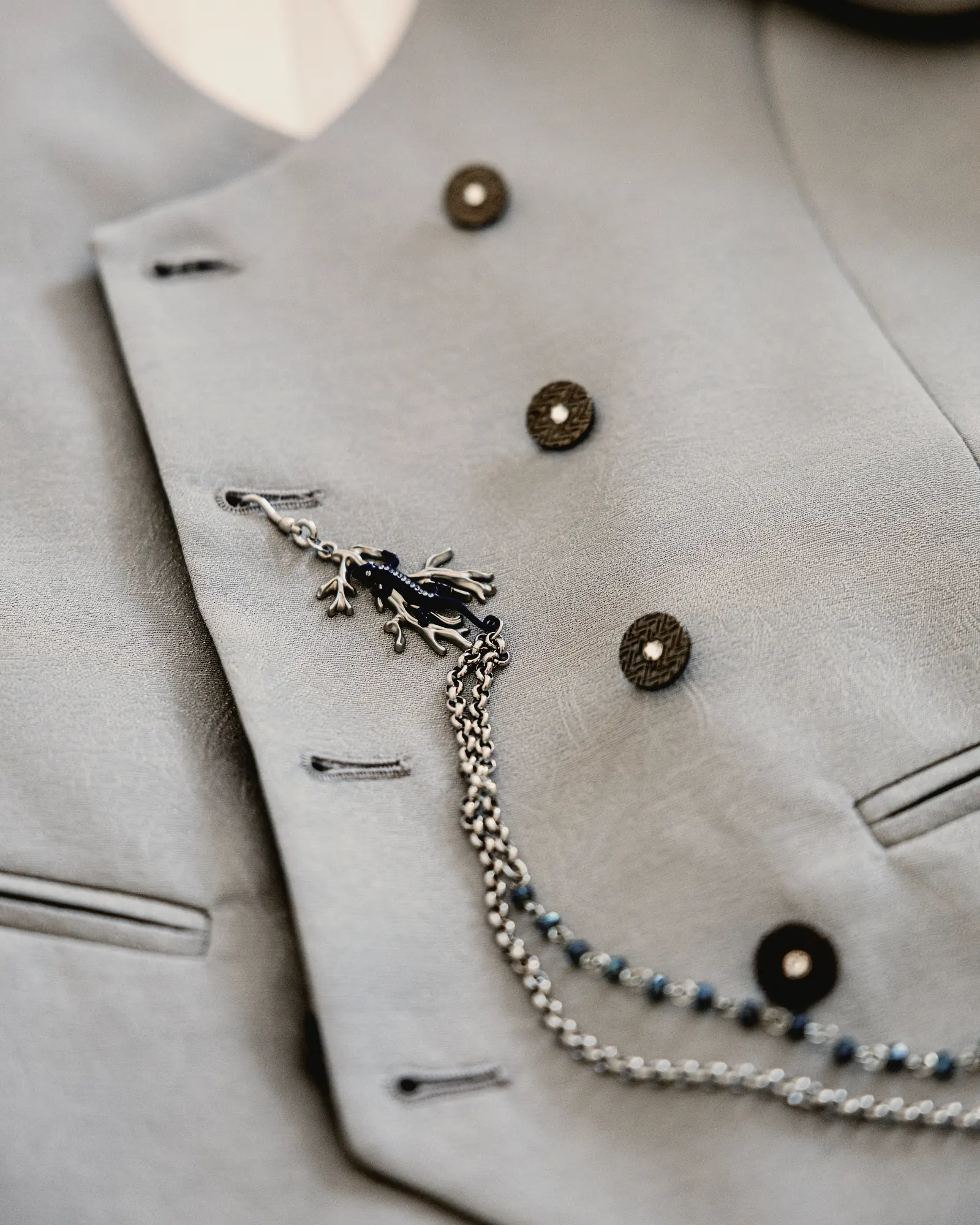 The pale grey waistcoat with its chain and buttons, laid out before it is worn.